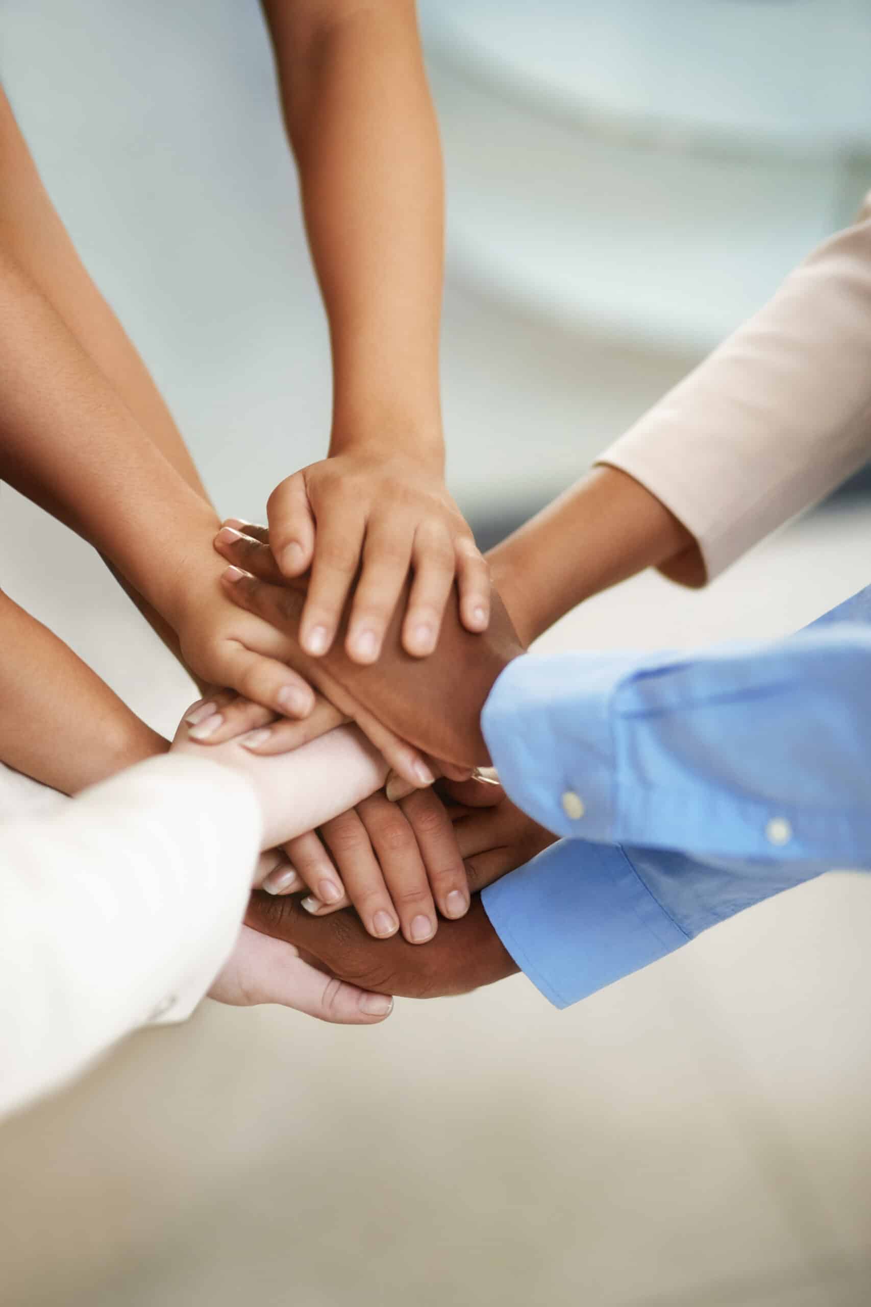 peoples hands together as a team